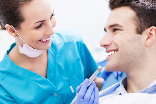 Female dentist with male patient