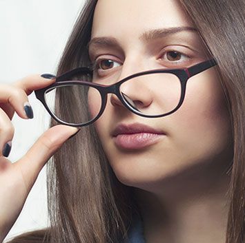 Woman holding down eyeglasses