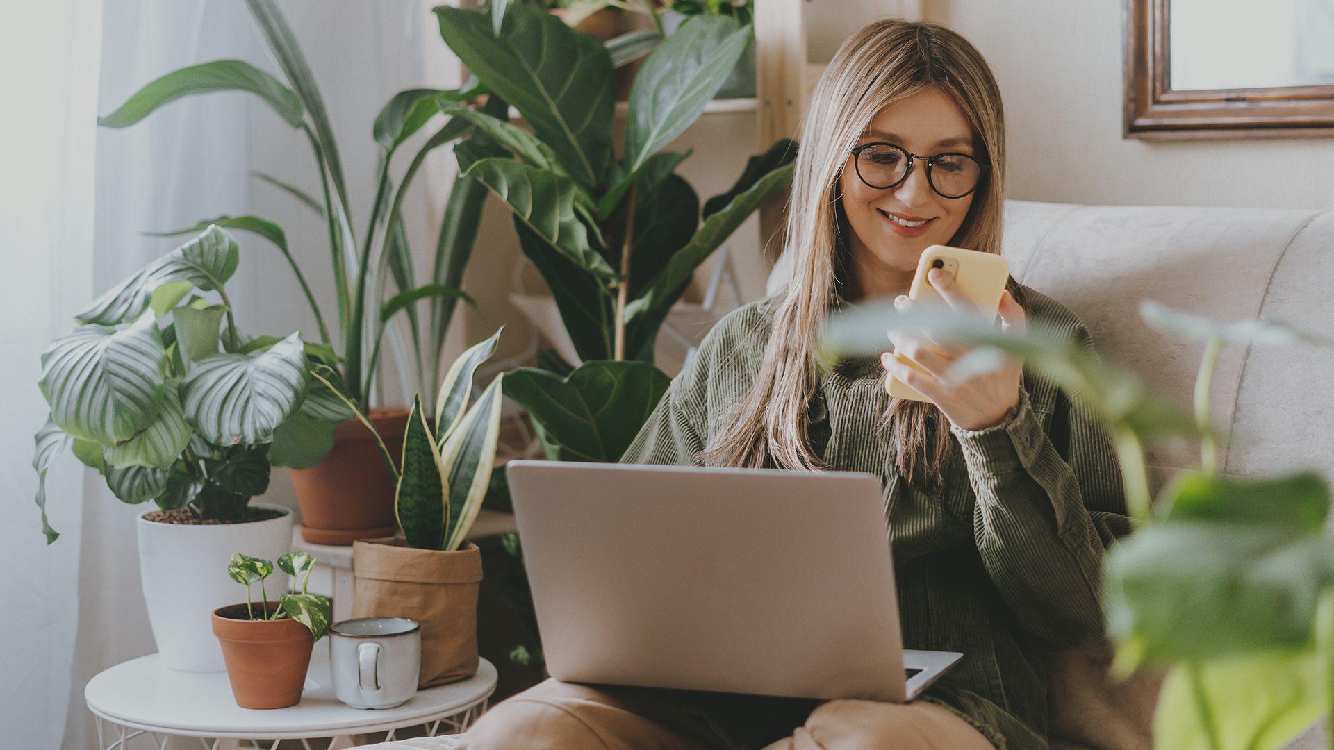 Woman with laptop and phone scheduling an appointment