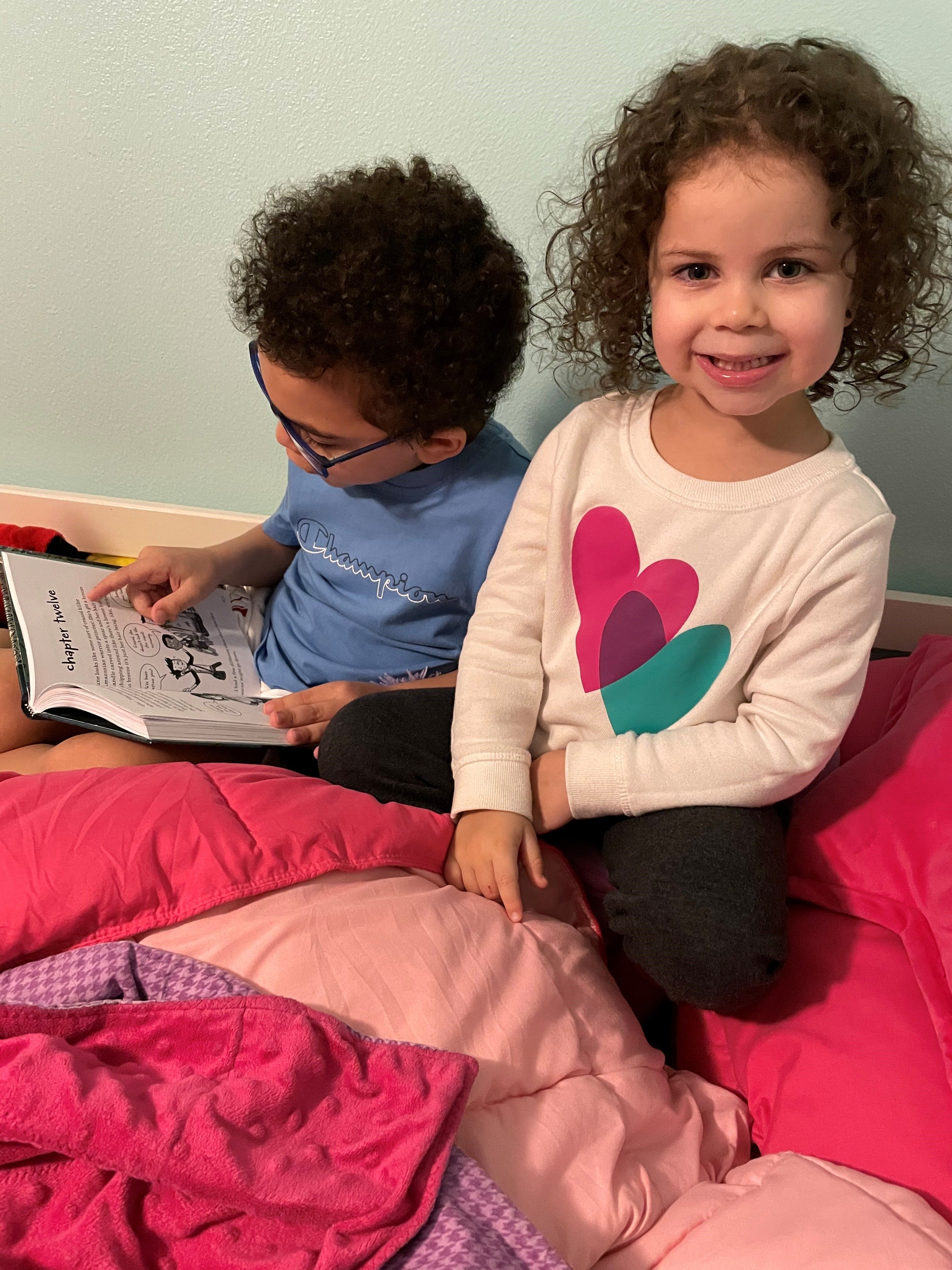 two young children reading books