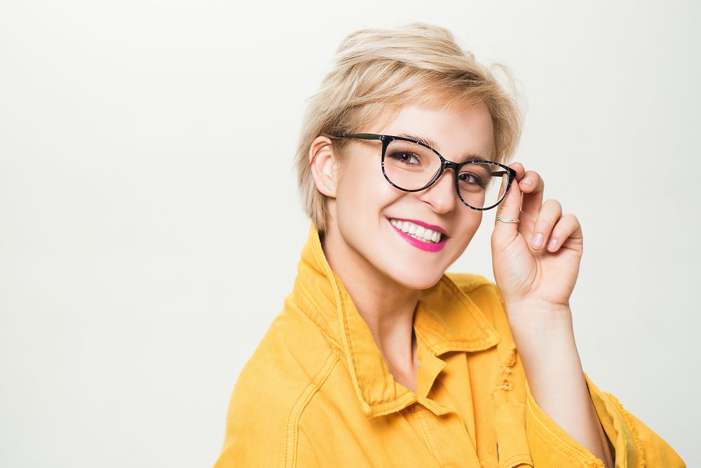 Blonde woman smiling wearing eyeglasses