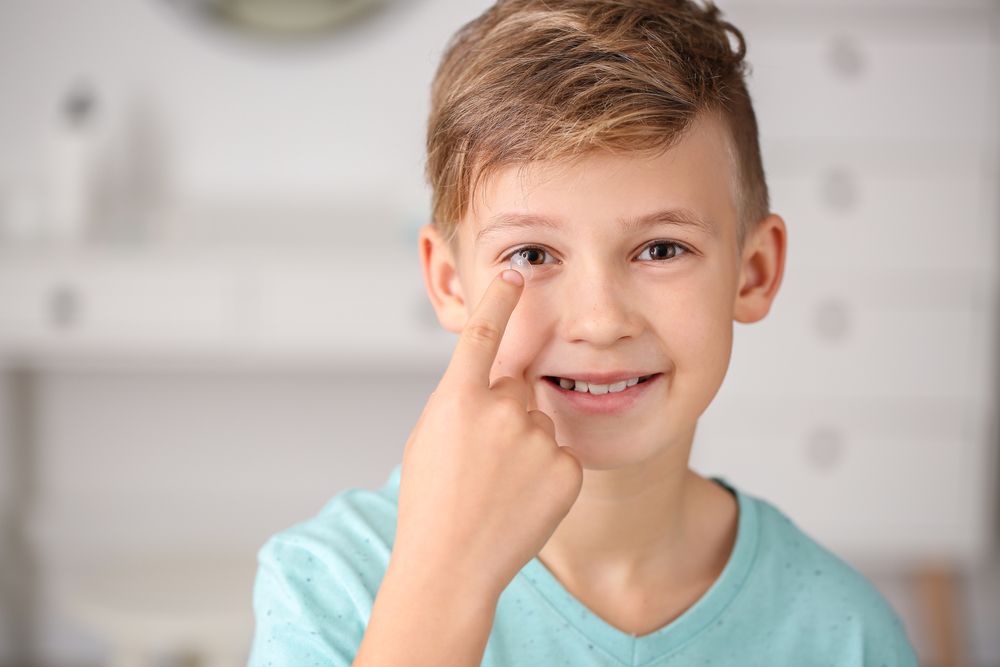 young boy using MiSight contacts