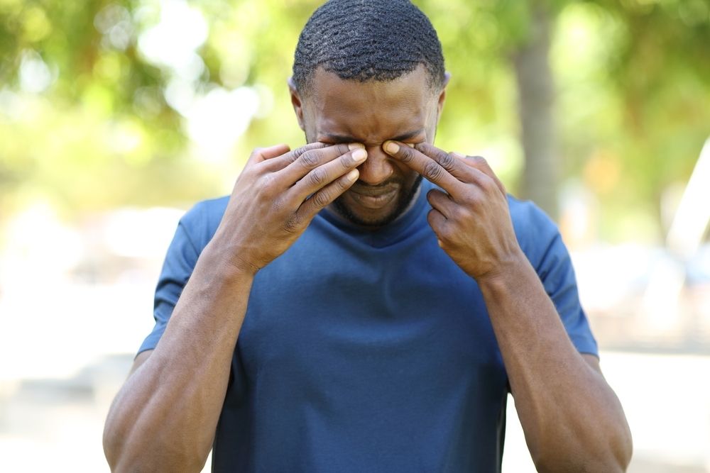 Man with allergies, itchy eyes
