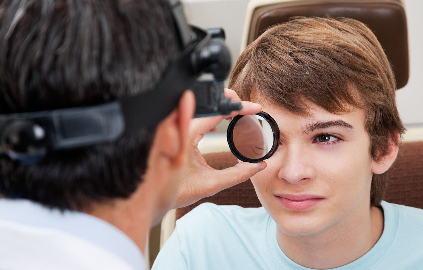Young man getting his eyes checked at the eye doctor's office