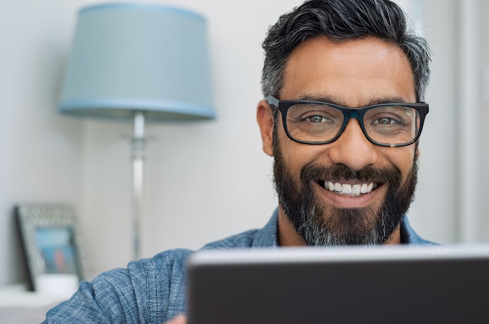 man with glasses smiling