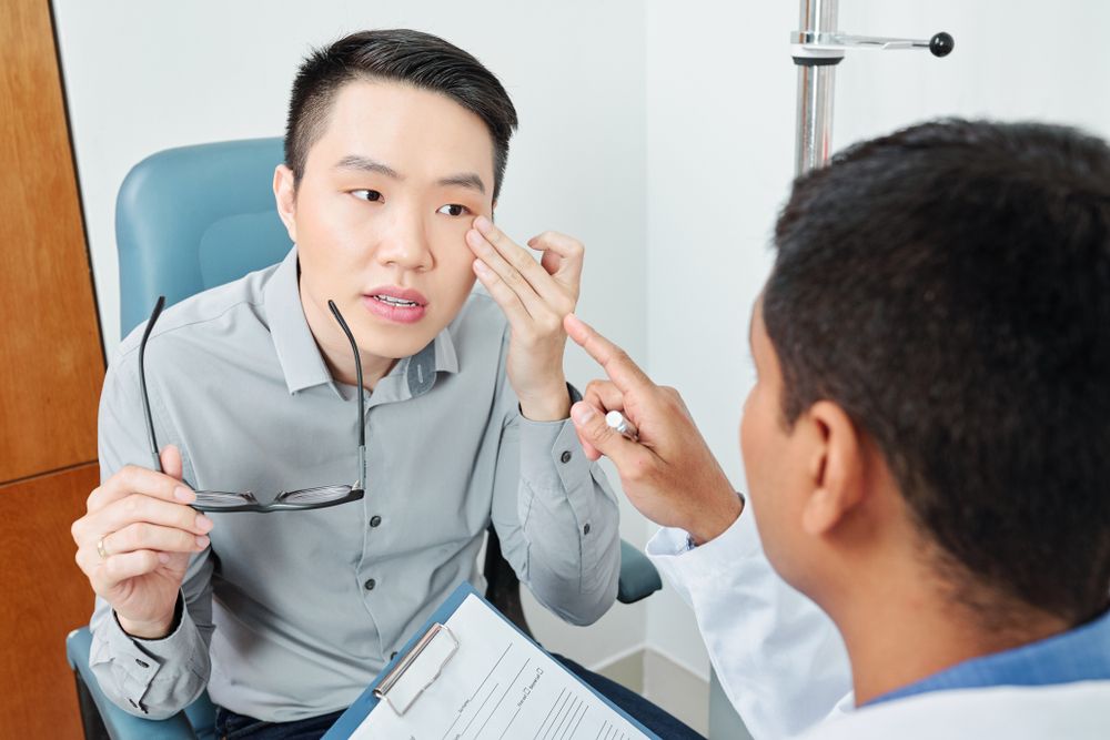 patient pointing at his eye and complaining to the doctor