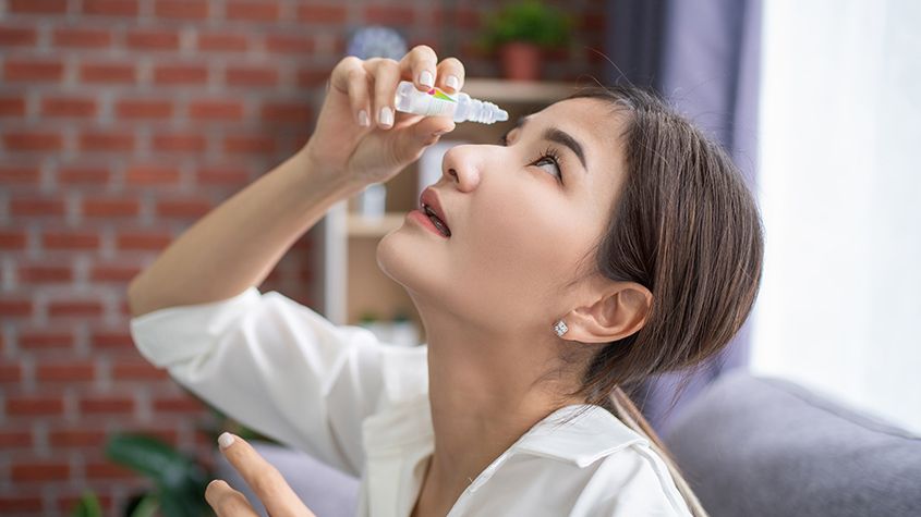 woman using eye drops for dry eye