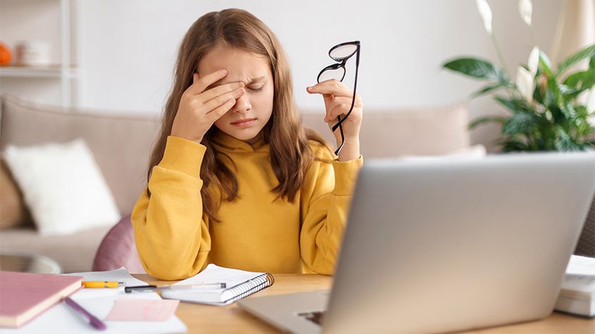 child with glasses and a headache