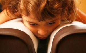 child with their face in a book