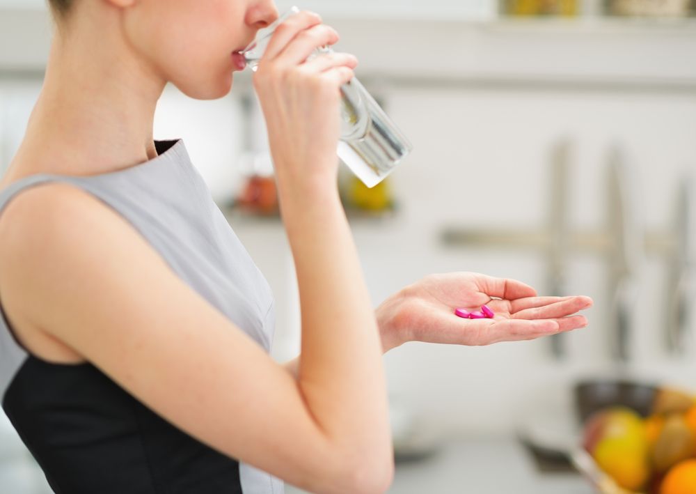 woman drinking antibiotics