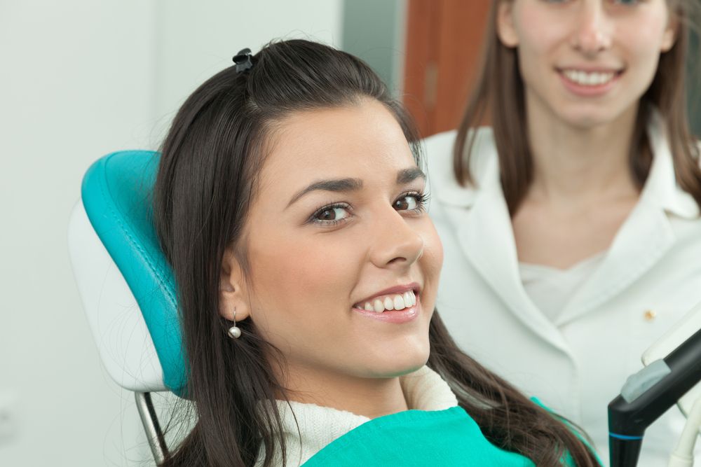 Woman smiling with dentist