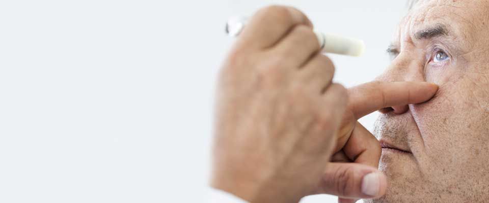 Elderly man getting eye exam