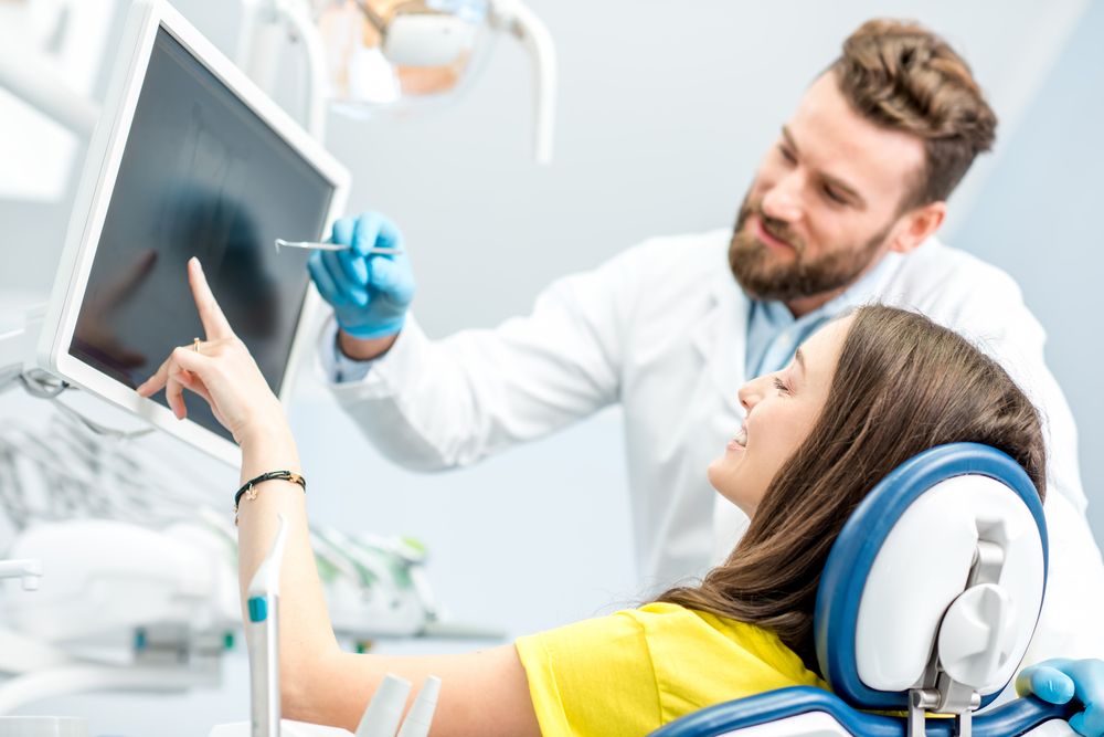 dentist showing results to patient