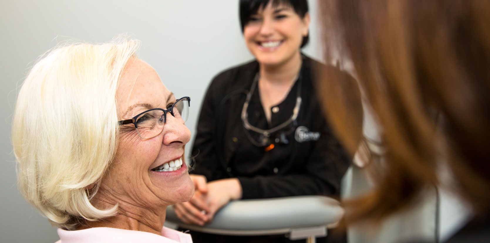 Happy old women with dental implants