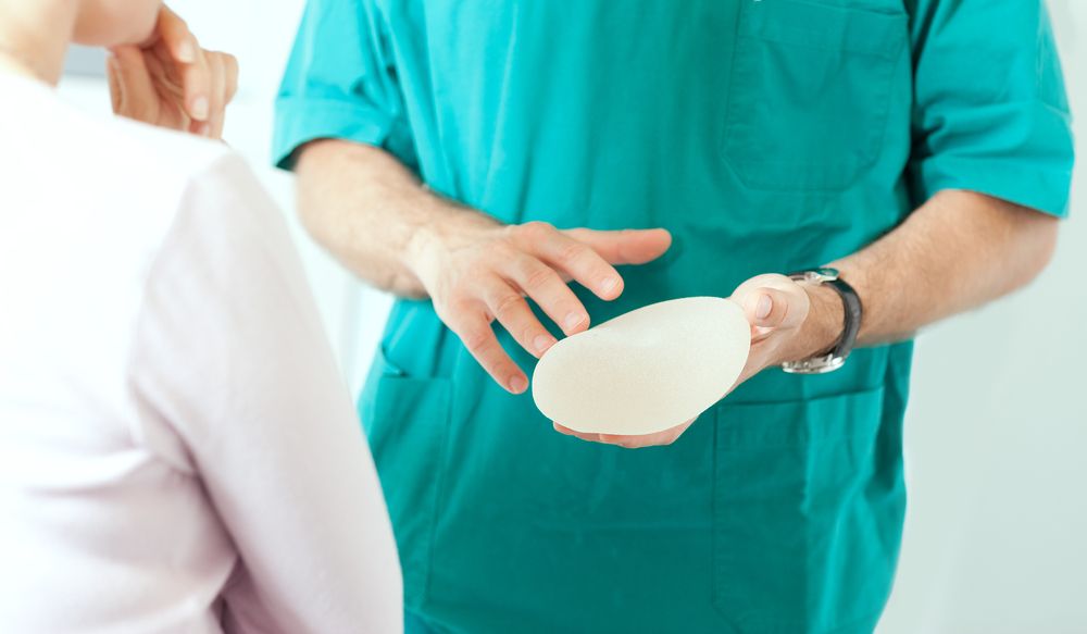 doctor with patient choosing breast implant