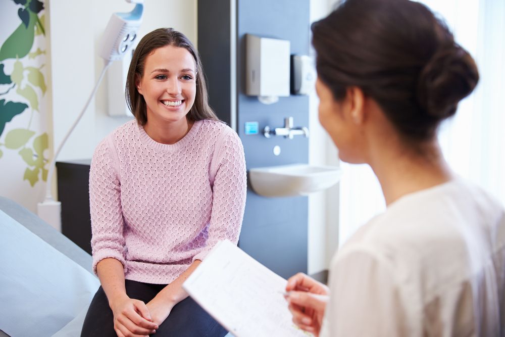 happy woman speaking with surgeon