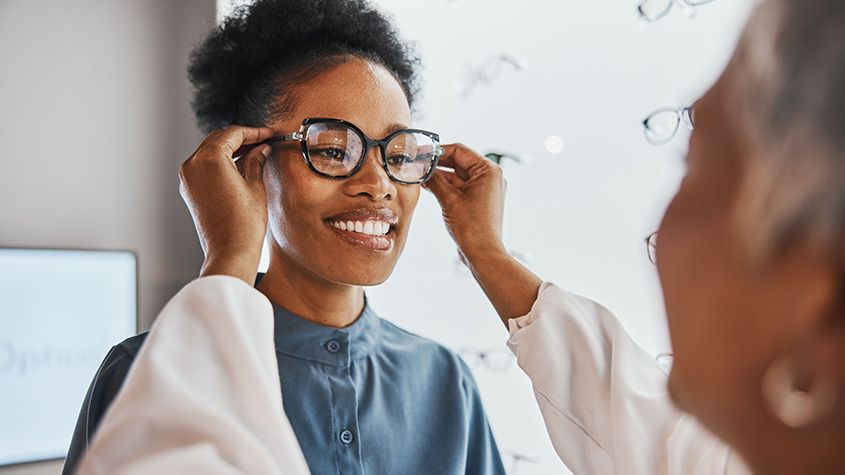 woman trying on eyeglasses in staten island