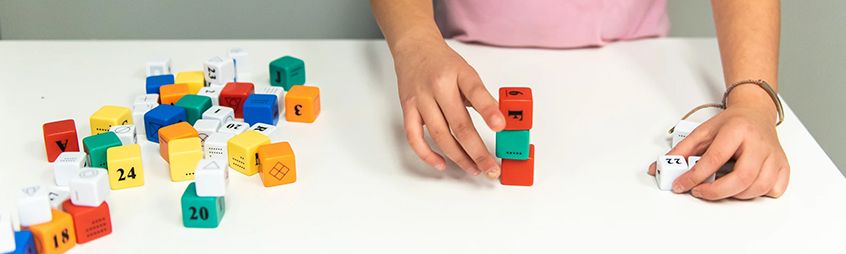 Kid playing with number cubes