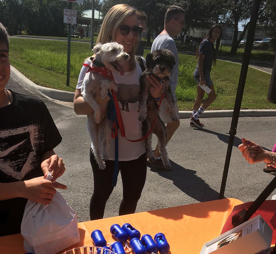 woman holding two dogs