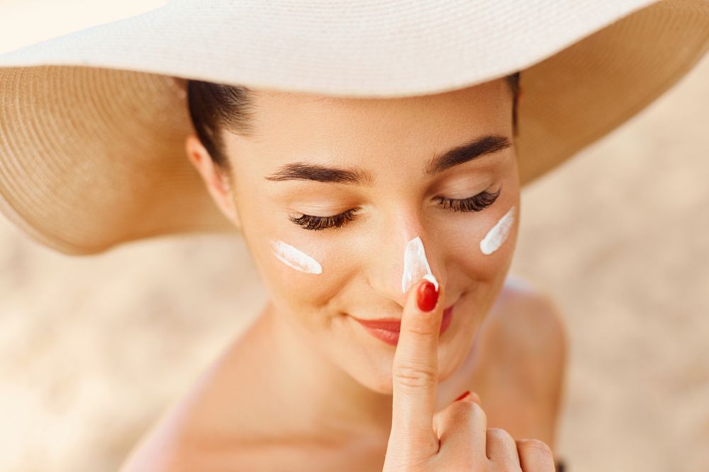 woman putting on sunscreen