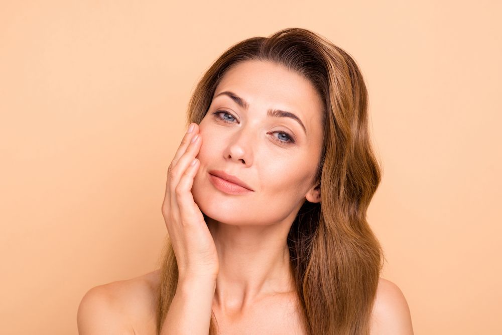 woman touching her smooth face