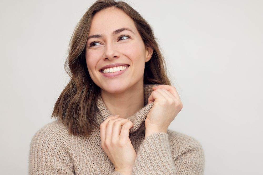 woman in a tan sweater