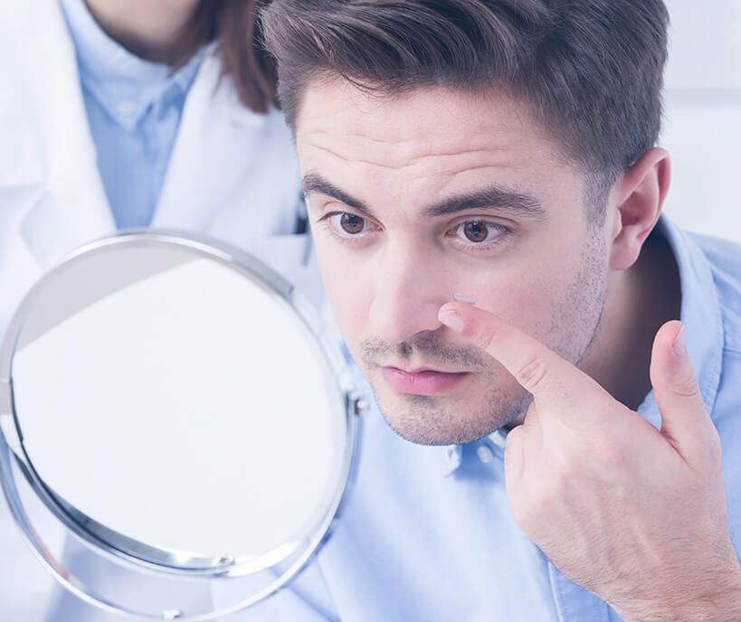 man putting in a contact lens