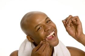 man flossing teeth