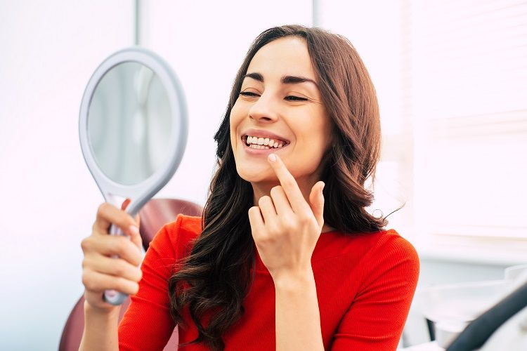 woman looking at her teeth