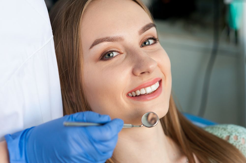 Beautiful smiling woman with dentist