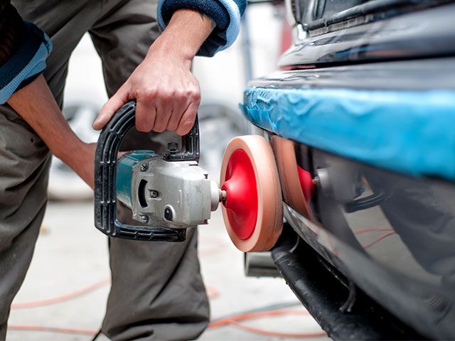 man repairing a car