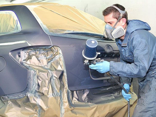 man repairing a car