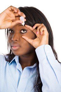 Woman putting eye drop for dry eyes