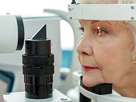 senior woman at the optometrist getting an eye exam