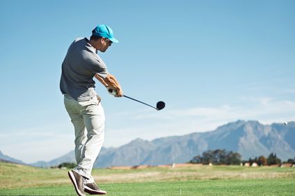 man striking ball with a golf club