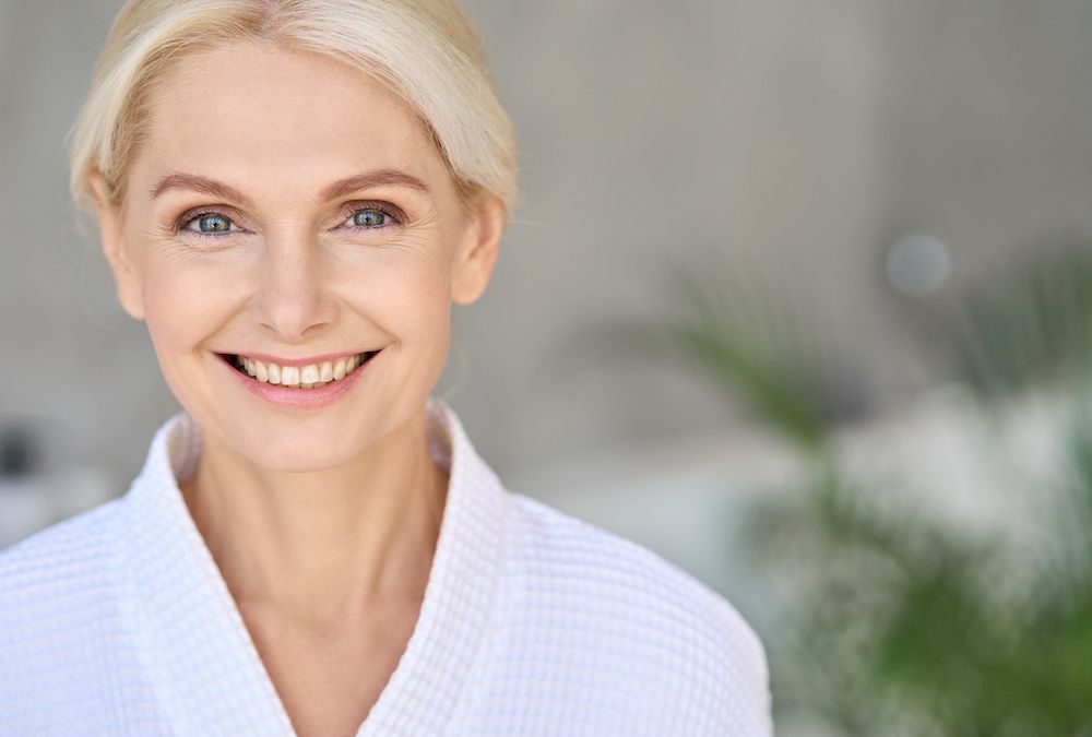 Older woman in white clothing smiling