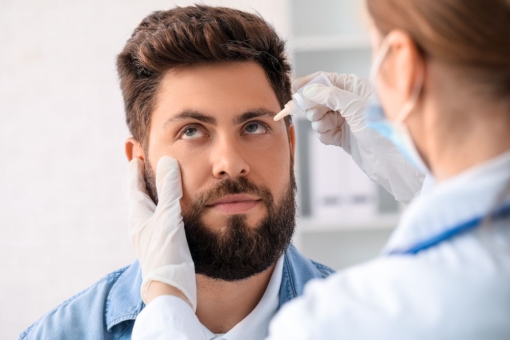 eye doctor administering dry eye drops