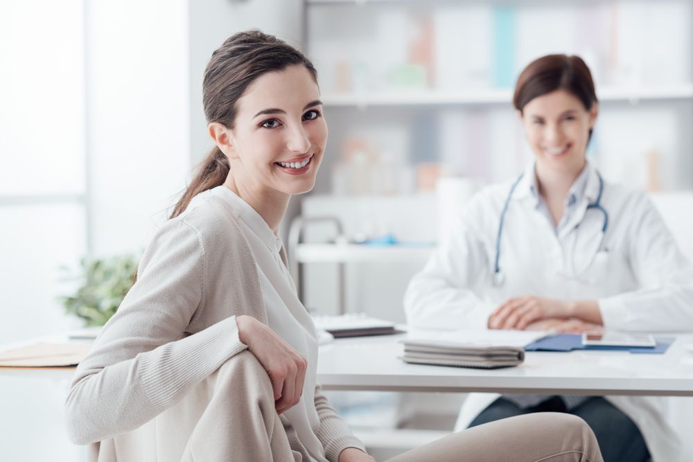 happy patient speaking with an eye surgeon