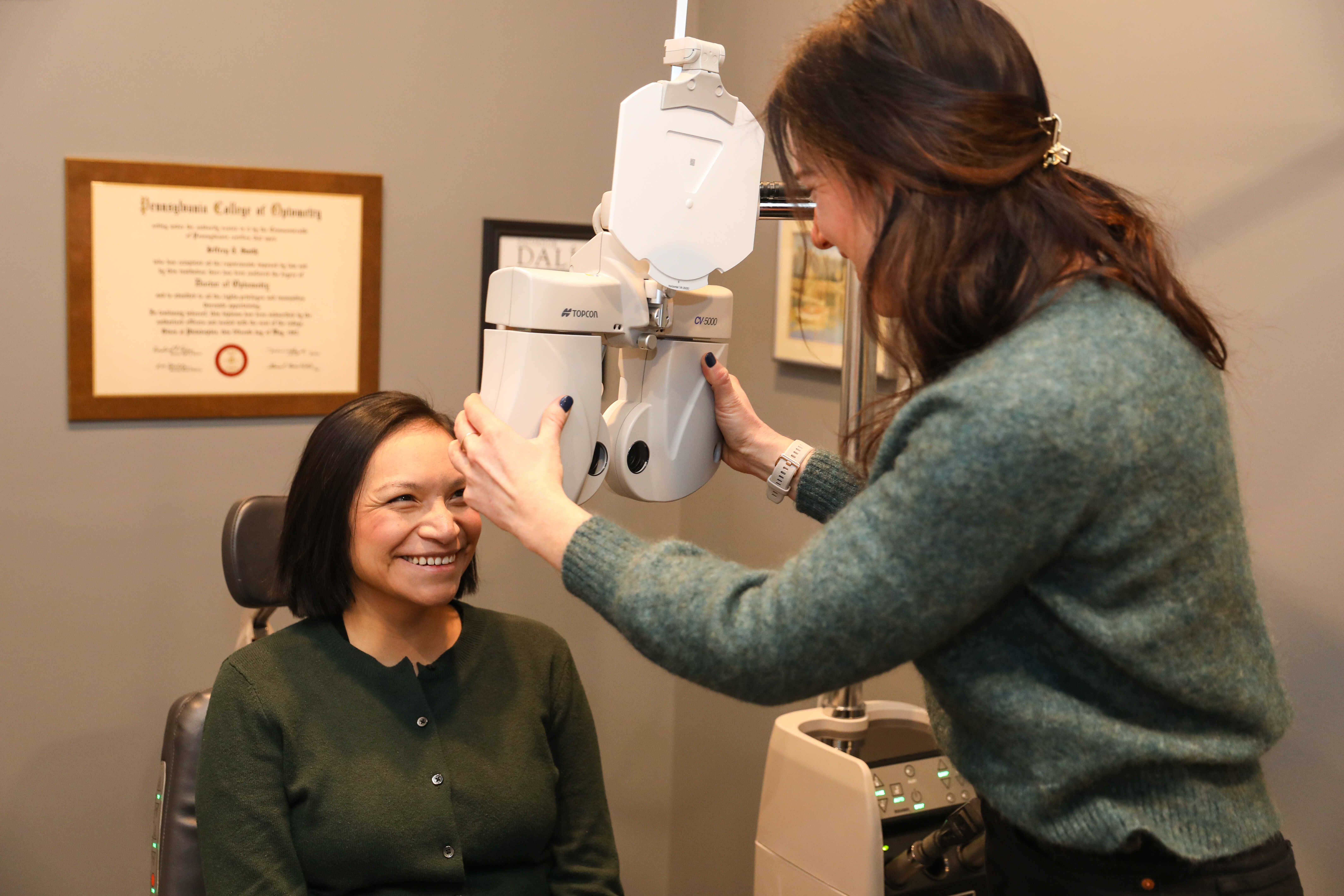 Optometrist beginning an eye exam for patient