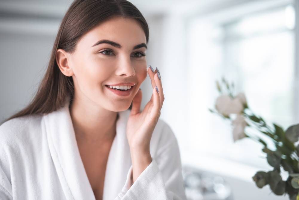 woman smiling looking in mirror