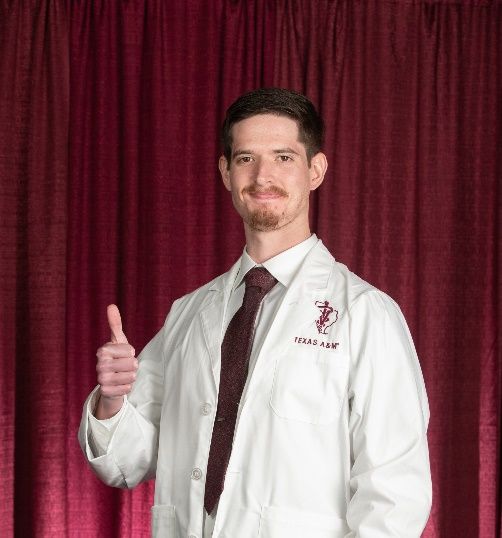 A person wearing a white coat and tie