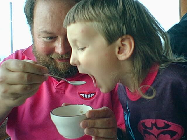 David drinking his soup with Dad's help