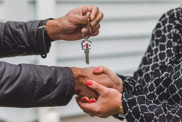 Handing over the key after a tenant rented the property.