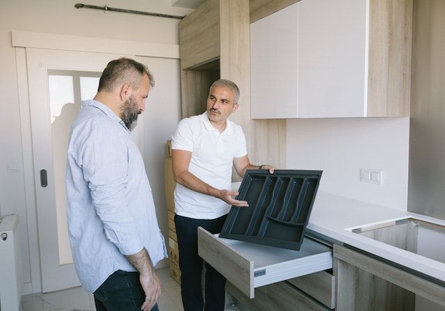 Landlord showing a kitchen to a potential tenant.