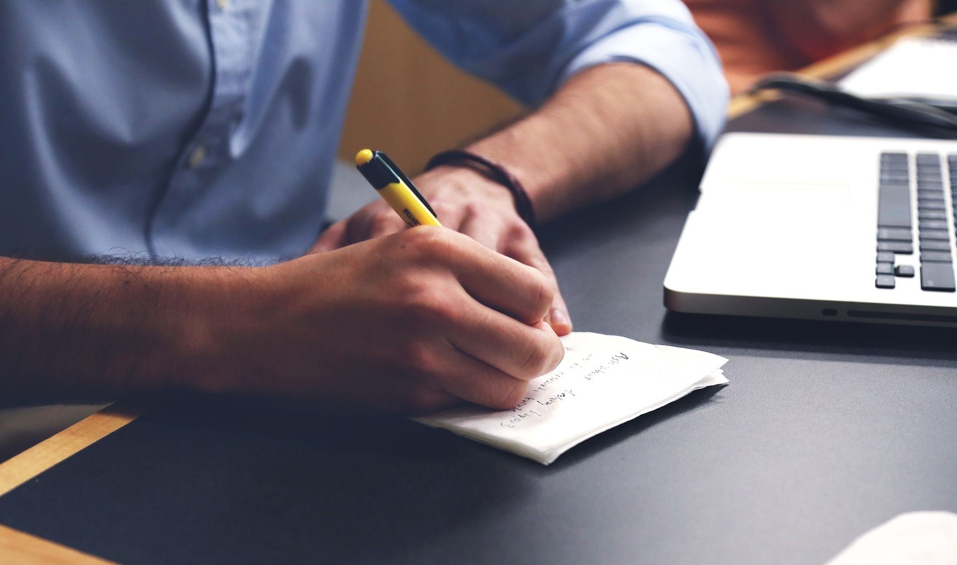 a man writing a marketing plan for rental properties